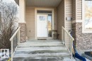 Entrance to property with covered porch and stone siding - 10535 67 Avenue, Edmonton, AB  - Outdoor With Exterior 