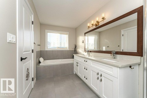 Full bathroom with double vanity, a garden tub, and light tile patterned flooring - 10535 67 Avenue, Edmonton, AB - Indoor Photo Showing Bathroom