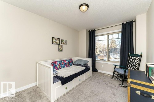 Bedroom featuring light carpet and a textured ceiling - 10535 67 Avenue, Edmonton, AB - Indoor