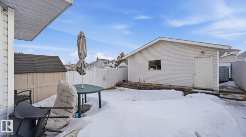 Snowy yard featuring a storage unit and a fenced backyard - 1509 Jarvis Cr, Edmonton, AB - Outdoor With Exterior