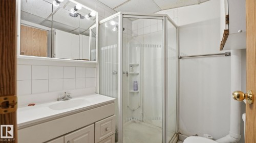 Full bathroom featuring vanity, a stall shower, and decorative backsplash - 1509 Jarvis Cr, Edmonton, AB - Indoor Photo Showing Bathroom