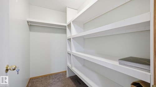 Walk in closet featuring dark colored carpet - 1509 Jarvis Cr, Edmonton, AB - Indoor