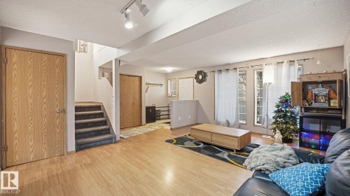 Living area with a textured ceiling, wood finished floors, and rail lighting - 1509 Jarvis Cr, Edmonton, AB - Indoor
