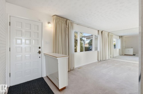 Foyer with light colored carpet and a textured ceiling - 12916 95A Street, Edmonton, AB - Indoor Photo Showing Other Room