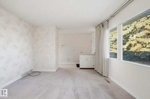 Unfurnished room with light colored carpet and wallpapered walls - 12916 95A Street, Edmonton, AB - Indoor Photo Showing Other Room