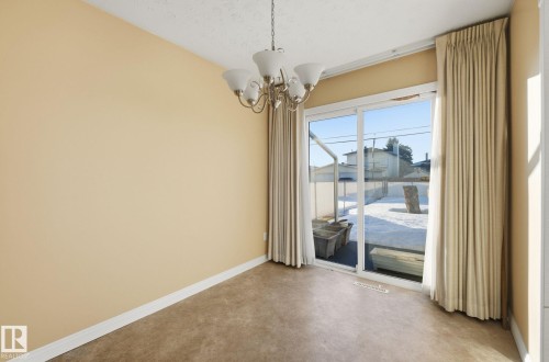 Empty room with suspended lighting and concrete flooring - 12916 95A Street, Edmonton, AB - Indoor Photo Showing Other Room