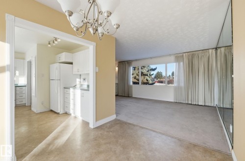 Unfurnished dining area featuring suspended lighting and finished concrete floors - 12916 95A Street, Edmonton, AB - Indoor