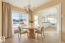 The dining area features a chandelier light fixture and sliding glass doors, offering views of the exterior - 12916 95A Street, Edmonton, AB  - Indoor Photo Showing Dining Room 