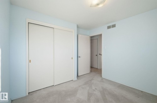 Unfurnished bedroom featuring light colored carpet and a closet - 12916 95A Street, Edmonton, AB - Indoor Photo Showing Other Room