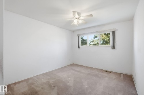 Empty room featuring carpet floors and a ceiling fan - 12916 95A Street, Edmonton, AB - Indoor Photo Showing Other Room