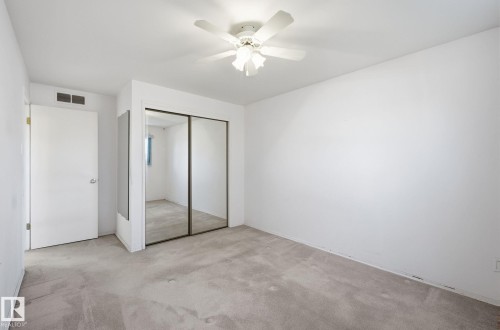 Unfurnished bedroom with a closet, light carpet, and a ceiling fan - 12916 95A Street, Edmonton, AB - Indoor Photo Showing Other Room