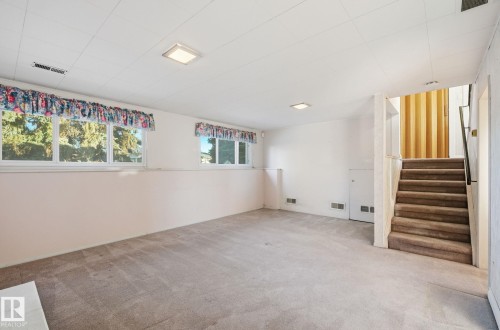 Basement with carpet and wallpapered walls - 12916 95A Street, Edmonton, AB - Indoor Photo Showing Other Room