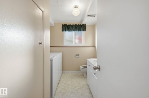 Full bathroom with vanity and separate washer and dryer - 12916 95A Street, Edmonton, AB - Indoor Photo Showing Bathroom