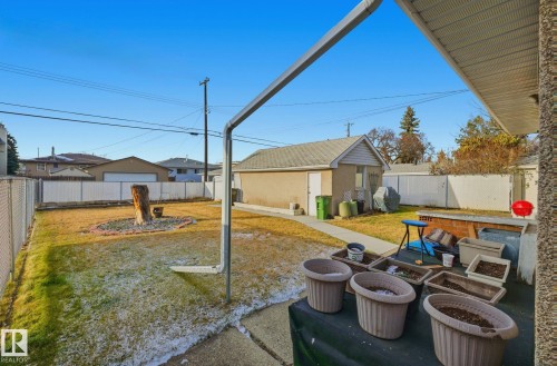 Fenced backyard with a patio area, an outdoor hangout area, and an outbuilding - 12916 95A Street, Edmonton, AB - Outdoor