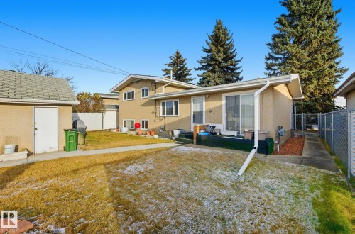 Back of property with stucco siding, a patio, and an outbuilding - 12916 95A Street, Edmonton, AB - Outdoor