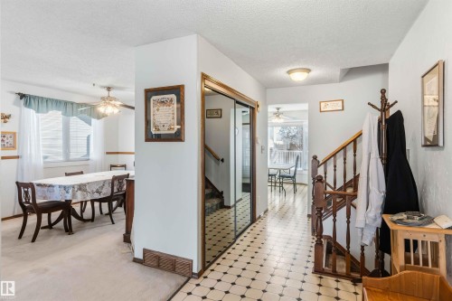 Foyer featuring a ceiling fan, a textured ceiling, and light floors - 17619 94 Ave, Edmonton, AB - Indoor