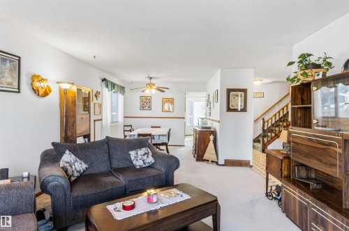 Carpeted living room with ceiling fan and a textured ceiling - 17619 94 Ave, Edmonton, AB - Indoor Photo Showing Living Room