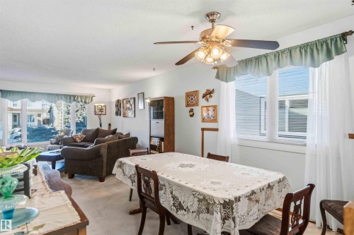 Dining room with light carpet, a textured ceiling, and ceiling fan - 17619 94 Ave, Edmonton, AB - Indoor Photo Showing Other Room