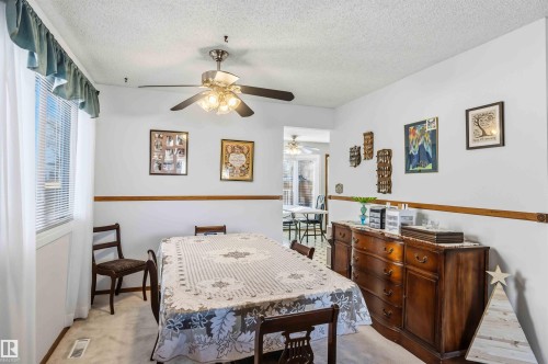 Dining room featuring a textured ceiling, light carpet, and plenty of natural light - 17619 94 Ave, Edmonton, AB - Indoor Photo Showing Dining Room