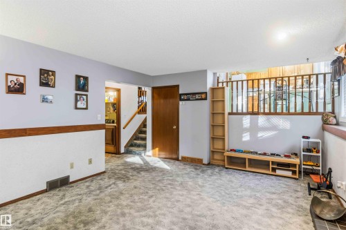 Unfurnished living room with carpet flooring and a textured ceiling - 17619 94 Ave, Edmonton, AB - Indoor Photo Showing Other Room