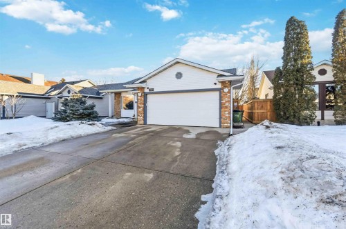 Ranch-style house featuring brick siding, concrete driveway, and an attached garage - 17619 94 Ave, Edmonton, AB - Outdoor