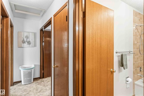 Corridor with a textured ceiling and attic access - 17619 94 Ave, Edmonton, AB - Indoor