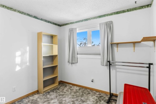 Unfurnished bedroom featuring a textured ceiling and carpet flooring - 17619 94 Ave, Edmonton, AB - Indoor