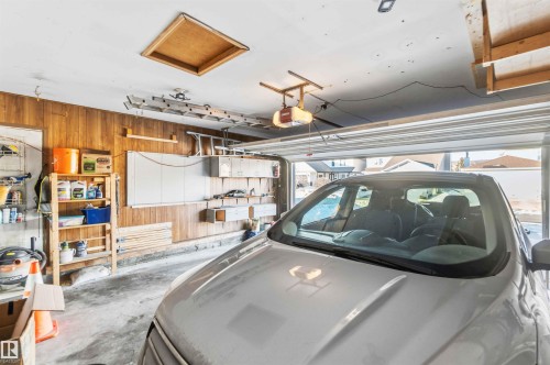 Garage featuring wood walls and a garage door opener - 17619 94 Ave, Edmonton, AB - Indoor Photo Showing Garage
