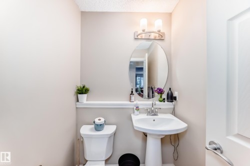 Half bath with toilet and a textured ceiling - 9645 Simpson Place, Edmonton, AB 