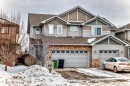 View of front facade with roof with shingles, a garage, driveway, and stone siding - 9645 Simpson Place, Edmonton, AB 