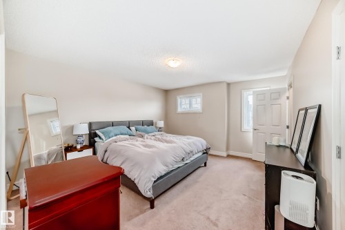 Bedroom with light carpet and baseboards - 9645 Simpson Place, Edmonton, AB 