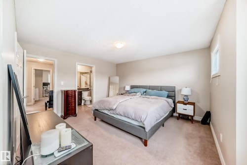 Bedroom with light carpet and ensuite bath - 9645 Simpson Place, Edmonton, AB 