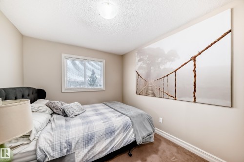 Bedroom featuring carpet and a textured ceiling - 9645 Simpson Place, Edmonton, AB 