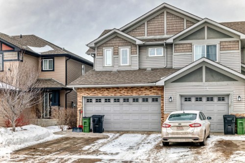 View of front of property with a shingled roof, an attached garage, and driveway - 9645 Simpson Place, Edmonton, AB 