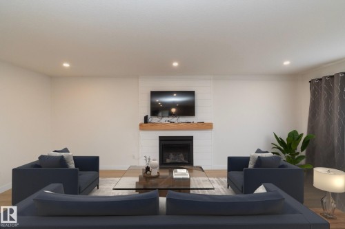 56 Brazeau Drive, Devon, AB - Indoor Photo Showing Living Room With Fireplace