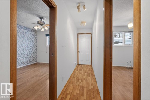 Corridor with a textured ceiling and light wood finished floors - Edmonton, AB - Indoor Photo Showing Other Room