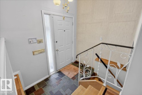 Entryway featuring suspended lighting and baseboards - Edmonton, AB - Indoor Photo Showing Other Room