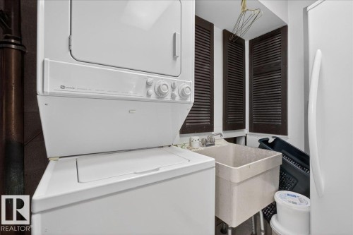 Laundry room with stacked washer / dryer - Edmonton, AB - Indoor Photo Showing Laundry Room