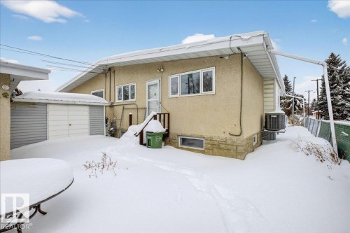 Snow covered house with a storage unit and stucco siding - Edmonton, AB - Outdoor