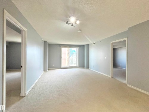 Unfurnished room featuring a textured ceiling and light carpet - 1402 10909 103 Avenue, Edmonton, AB - Indoor Photo Showing Other Room