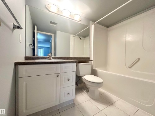 Bathroom featuring shower / bath combination, vanity, and light tile patterned floors - 1402 10909 103 Avenue, Edmonton, AB - Indoor Photo Showing Bathroom