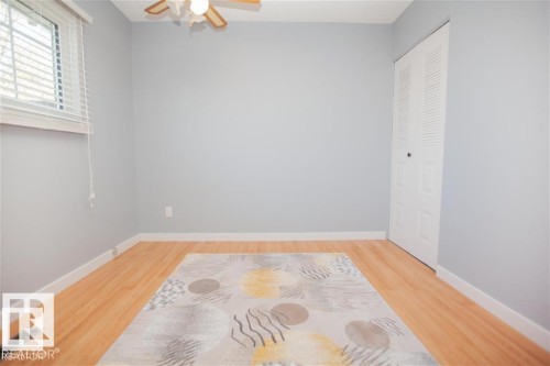 Unfurnished bedroom with light wood-type flooring, a ceiling fan, and a closet - 17208 106 Street, Edmonton, AB - Indoor Photo Showing Other Room