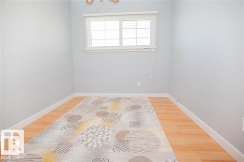 Unfurnished room with baseboards and light wood-style floors - 17208 106 Street, Edmonton, AB - Indoor Photo Showing Other Room