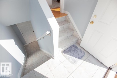 Stairway featuring tile patterned floors and baseboards - 17208 106 Street, Edmonton, AB - Indoor Photo Showing Other Room