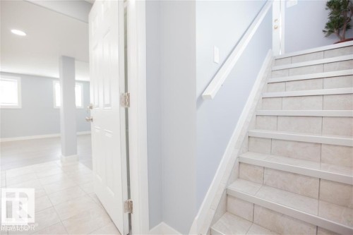 Staircase featuring tile patterned floors and recessed lighting - 17208 106 Street, Edmonton, AB - Indoor Photo Showing Other Room