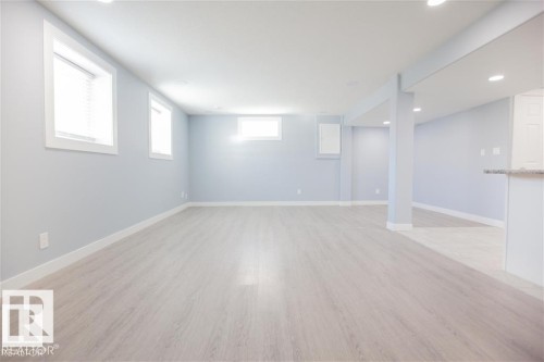 Basement with light wood finished floors and recessed lighting - 17208 106 Street, Edmonton, AB - Indoor