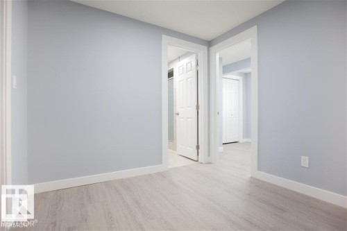 Spare room featuring light wood finished floors and baseboards - 17208 106 Street, Edmonton, AB - Indoor Photo Showing Other Room