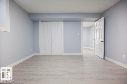 Unfurnished bedroom with a closet and light wood-style flooring - 17208 106 Street, Edmonton, AB - Indoor Photo Showing Other Room