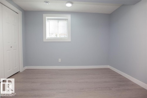 Unfurnished bedroom featuring a closet and light wood-style flooring - 17208 106 Street, Edmonton, AB - Indoor Photo Showing Other Room