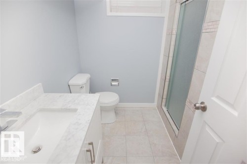 Bathroom with vanity, a stall shower, and light tile patterned flooring - 17208 106 Street, Edmonton, AB - Indoor Photo Showing Bathroom